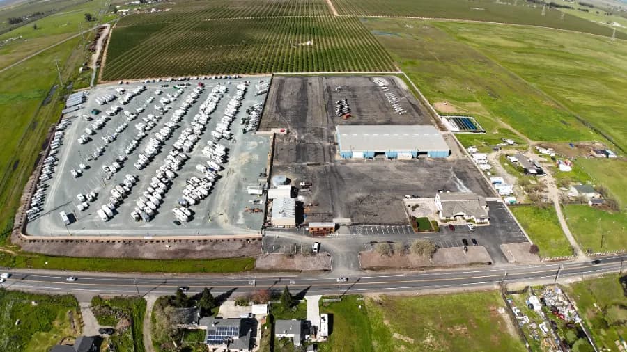 Aerial view of an industrial warehouse building and RV storage yard being converted into modern self-storage by Storage Moguls