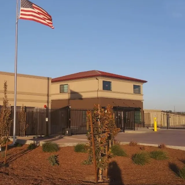 Exterior of a repositioned climate-controlled self-storage facility with modern office and signage